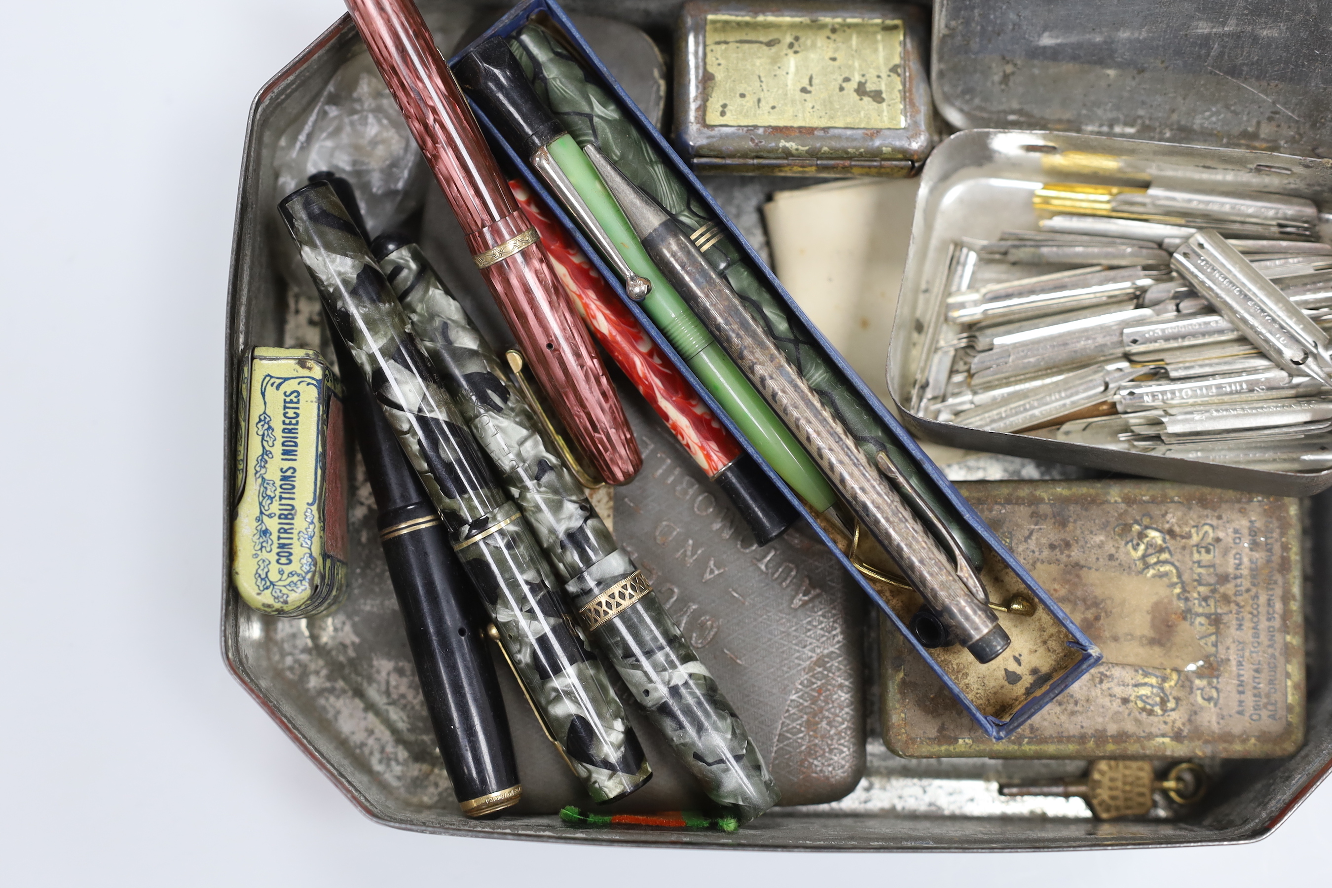 A collection of gold nibbed fountain pens and a collection of nibs